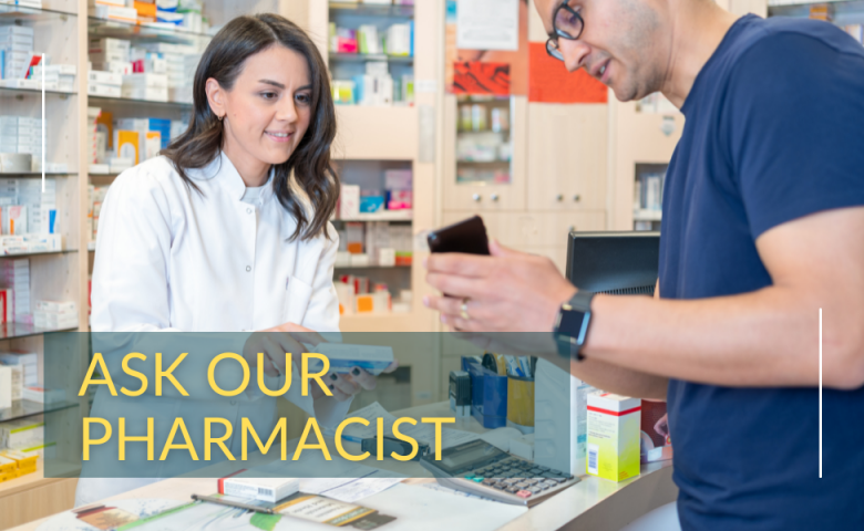 Male patient shows female pharmacist his mobile phone during consultation at pharmacy
