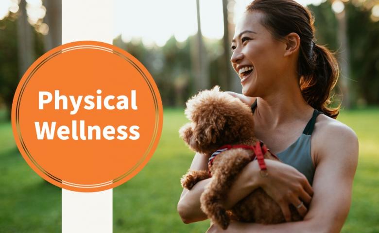 Woman holding a small dog while smiling. Orange circle next to her reads Physical Wellness.