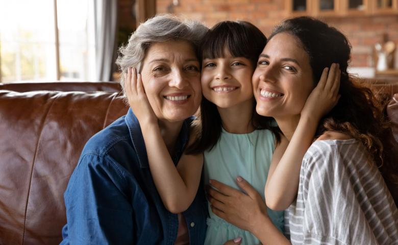 Portrait of three generations of women hugging